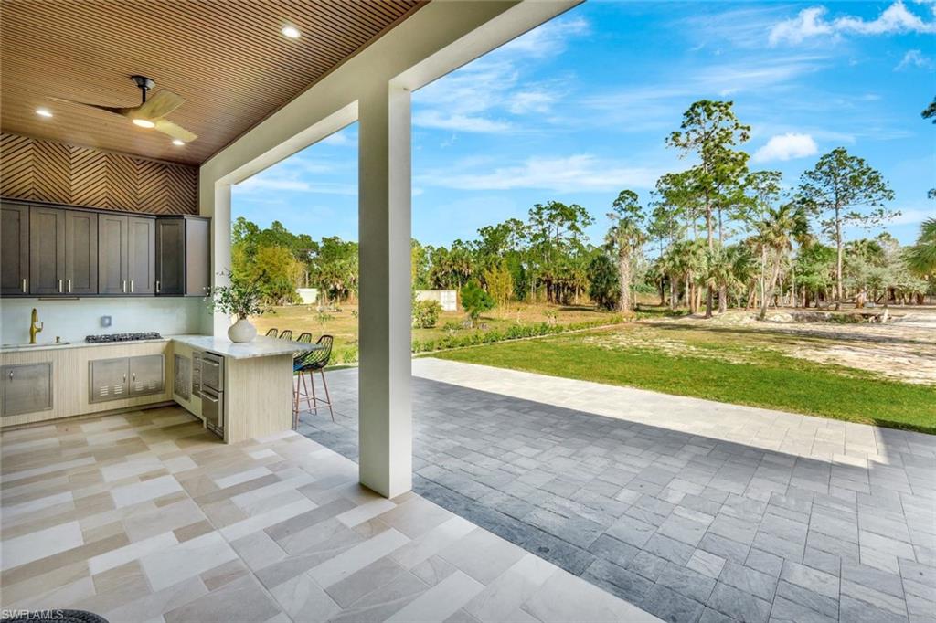 2546 4th Street Northwest Naples, FL 34120 - Photo 25 of 44 a view of a kitchen with a sink and a fireplace