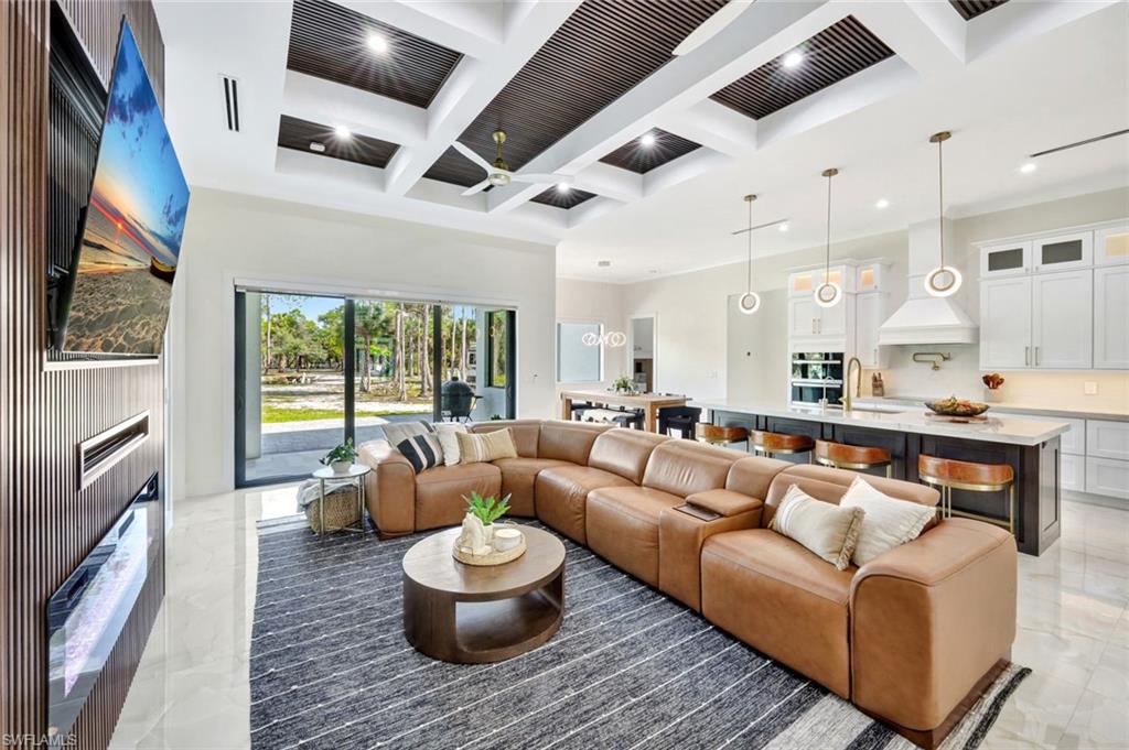 2546 4th Street Northwest Naples, FL 34120 - Photo 3 of 44 a living room with furniture and a wooden floor