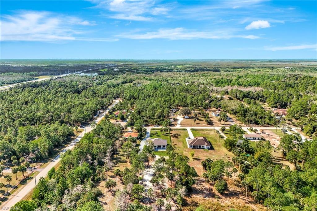 2546 4th Street Northwest Naples, FL 34120 - Photo 34 of 44 Aerial overview of property's location with a forest