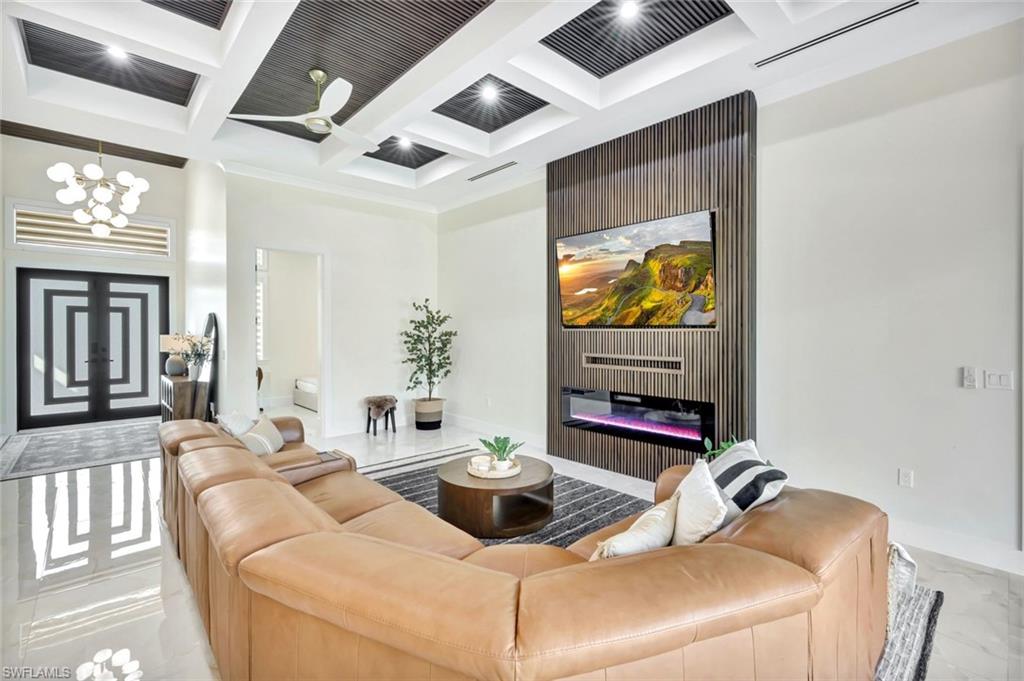 2546 4th Street Northwest Naples, FL 34120 - Photo 4 of 44 a living room with furniture and a flat screen tv