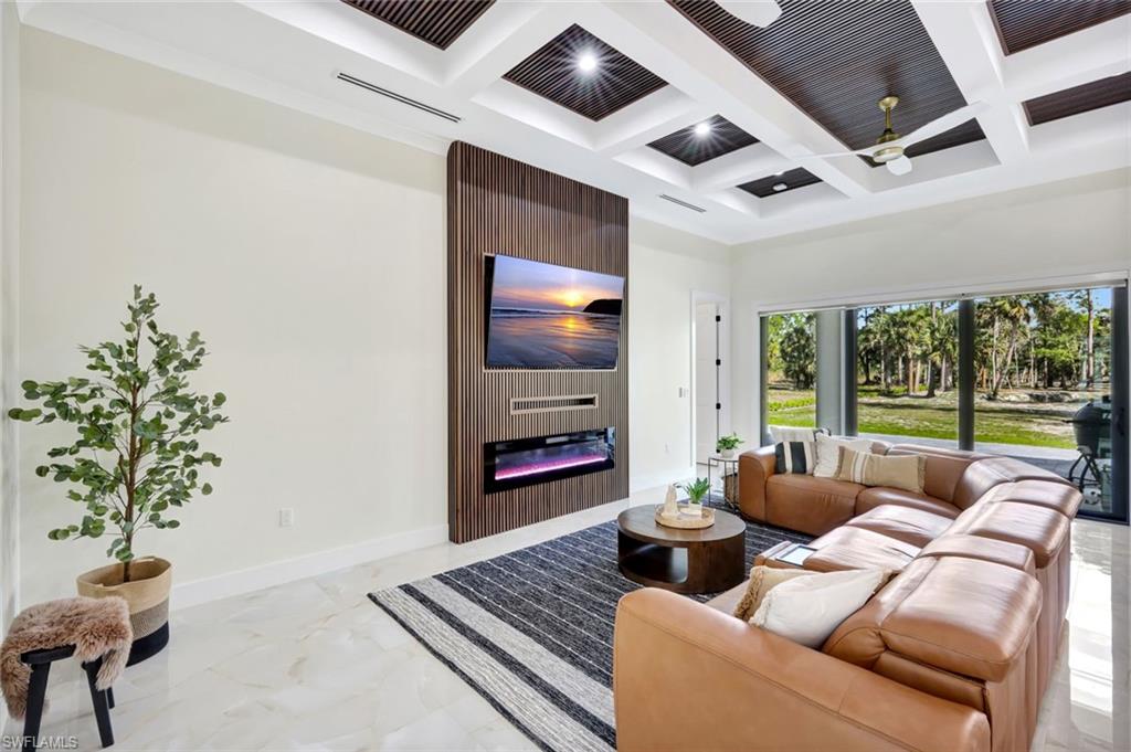 2546 4th Street Northwest Naples, FL 34120 - Photo 6 of 44 a living room with furniture and a flat screen tv