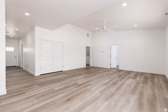 51 West 500 South Monroe, UT 84754 - Photo 11 of 41 Spacious room featuring wood-finish flooring, white walls, vaulted ceilings, recessed lighting, and a ceiling fan