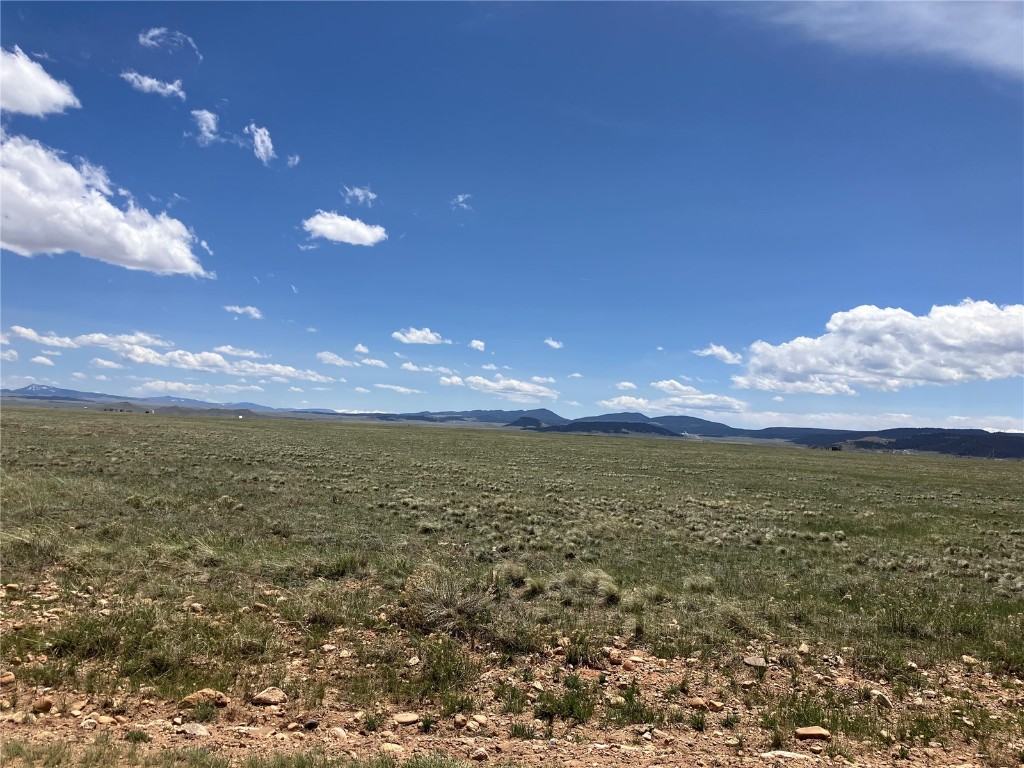 View of local wilderness featuring a rural view and a mountain view