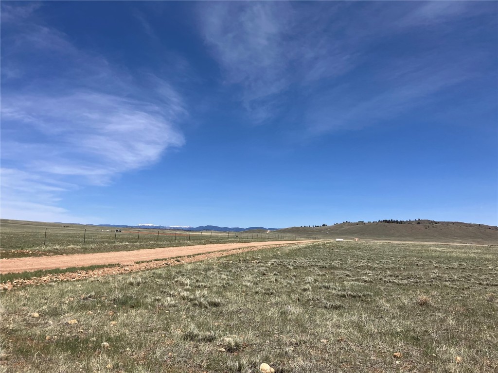 View of yard with a rural view