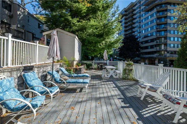 a view of balcony with wooden floor and outdoor seating