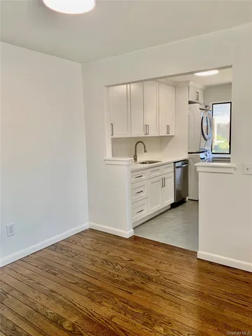 a view of a kitchen with a sink cabinets and wooden floor