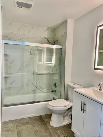 a bathroom with a toilet a sink and shower