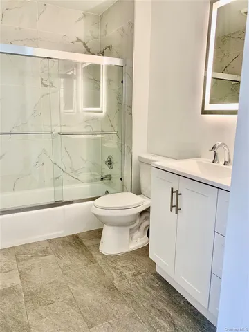 a white toilet sitting next to a bathroom sink