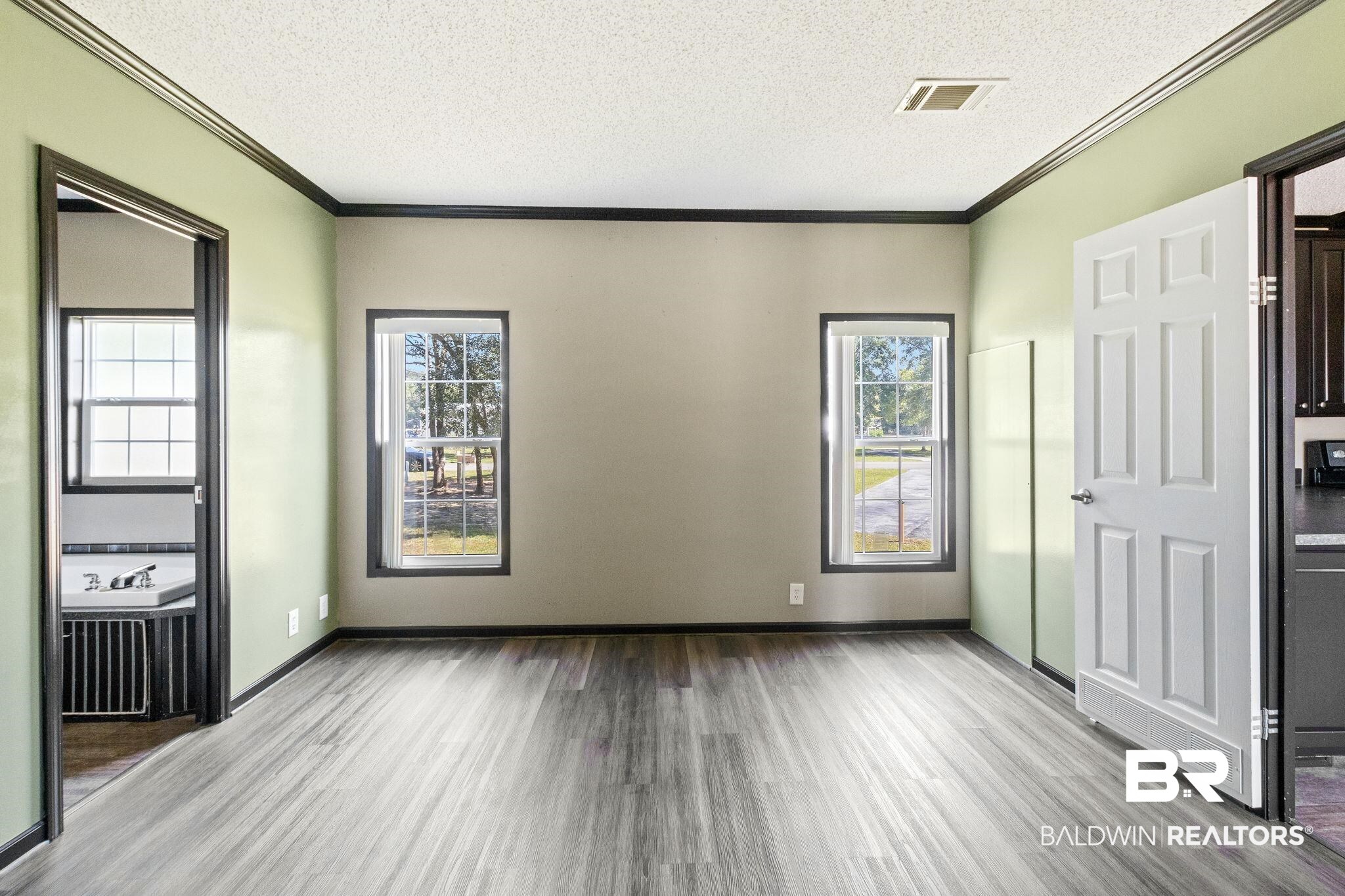6870 Cecilia Court Theodore, AL 36582 - Photo 31 of 83 Unfurnished bedroom featuring light hardwood / wood-style flooring and multiple windows