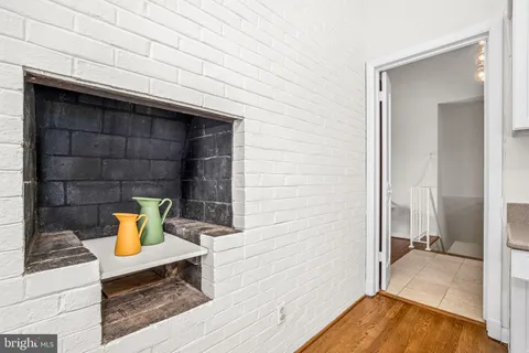 a kitchen with a sink cabinets and wooden floor