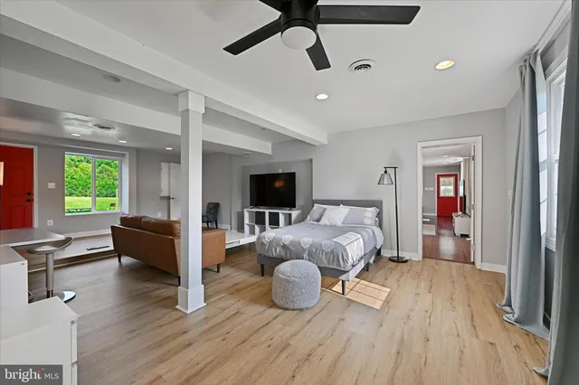 a bedroom with furniture and a wooden floor