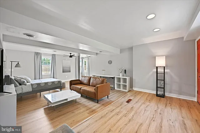 a living room with furniture and a wooden floor