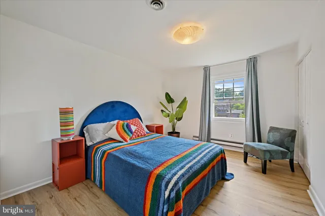 a bedroom with a bed and a window