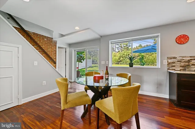 a dining room with furniture and wooden floor