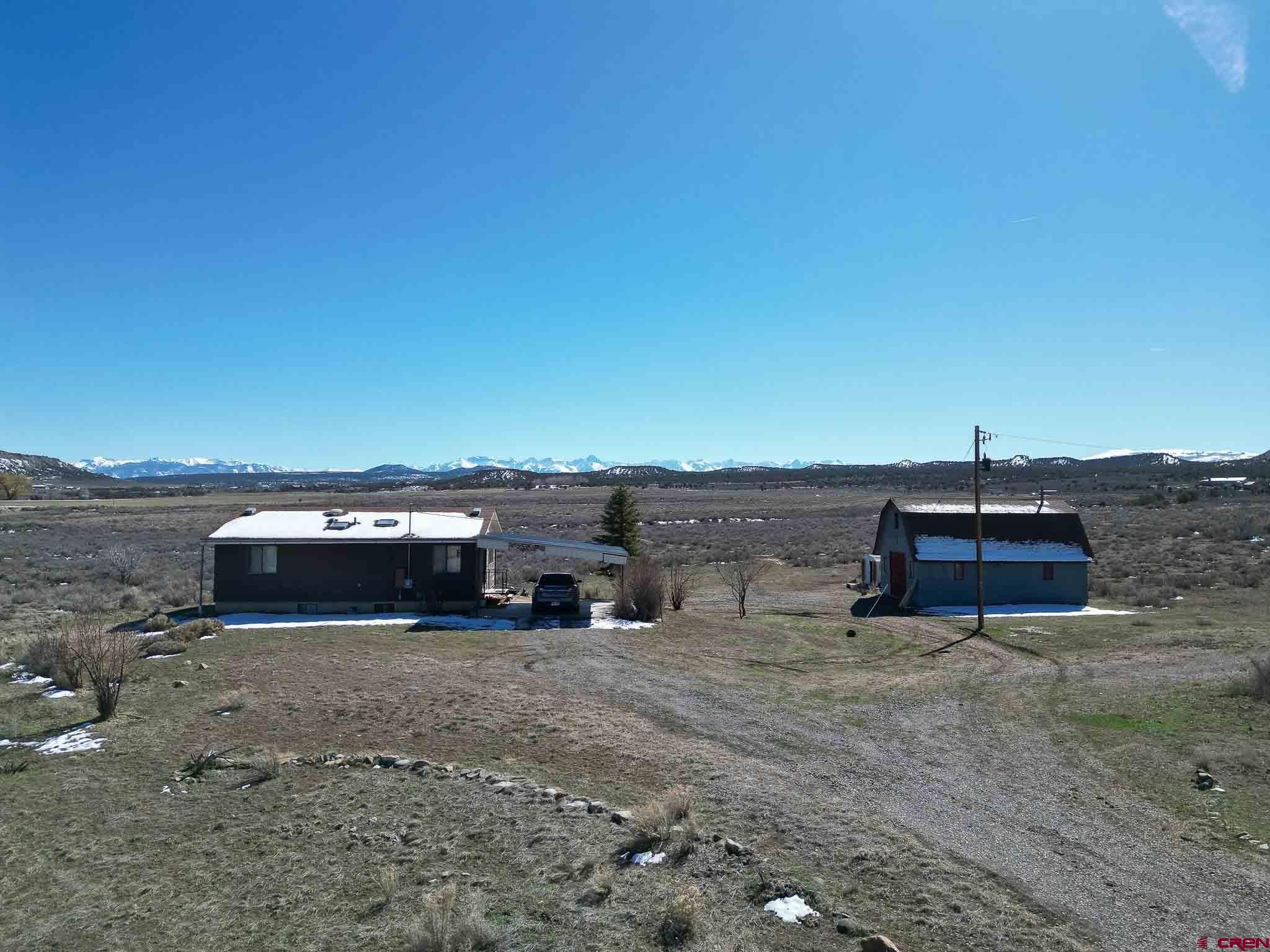 an aerial view of a house with a yard