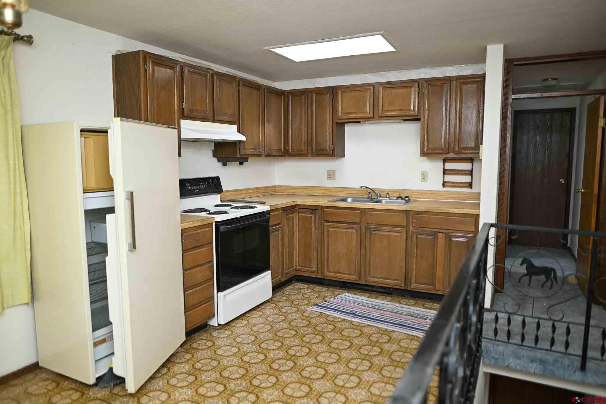 22120 Government Springs Road Montrose, CO 81403 - Photo 12 of 28 a kitchen with stainless steel appliances granite countertop a refrigerator sink and cabinets