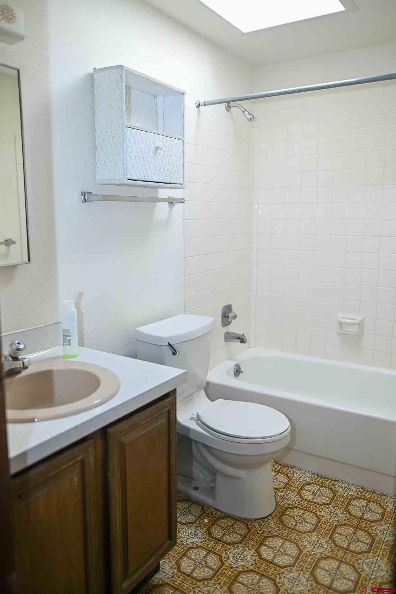 22120 Government Springs Road Montrose, CO 81403 - Photo 16 of 28 a bathroom with a sink a toilet and a bathtub