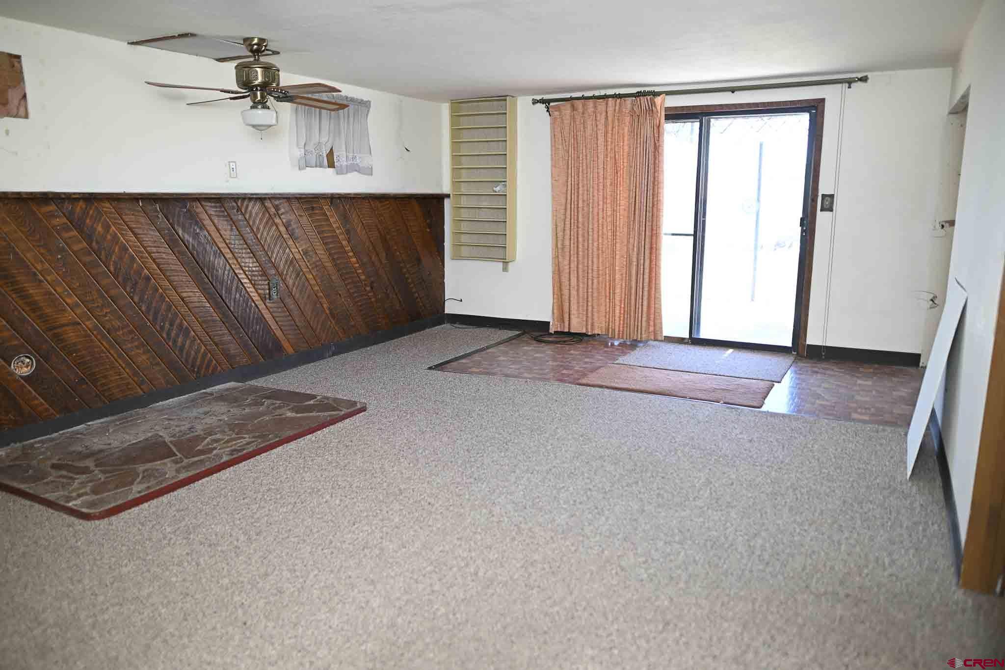 22120 Government Springs Road Montrose, CO 81403 - Photo 25 of 28 an empty room with windows and fan
