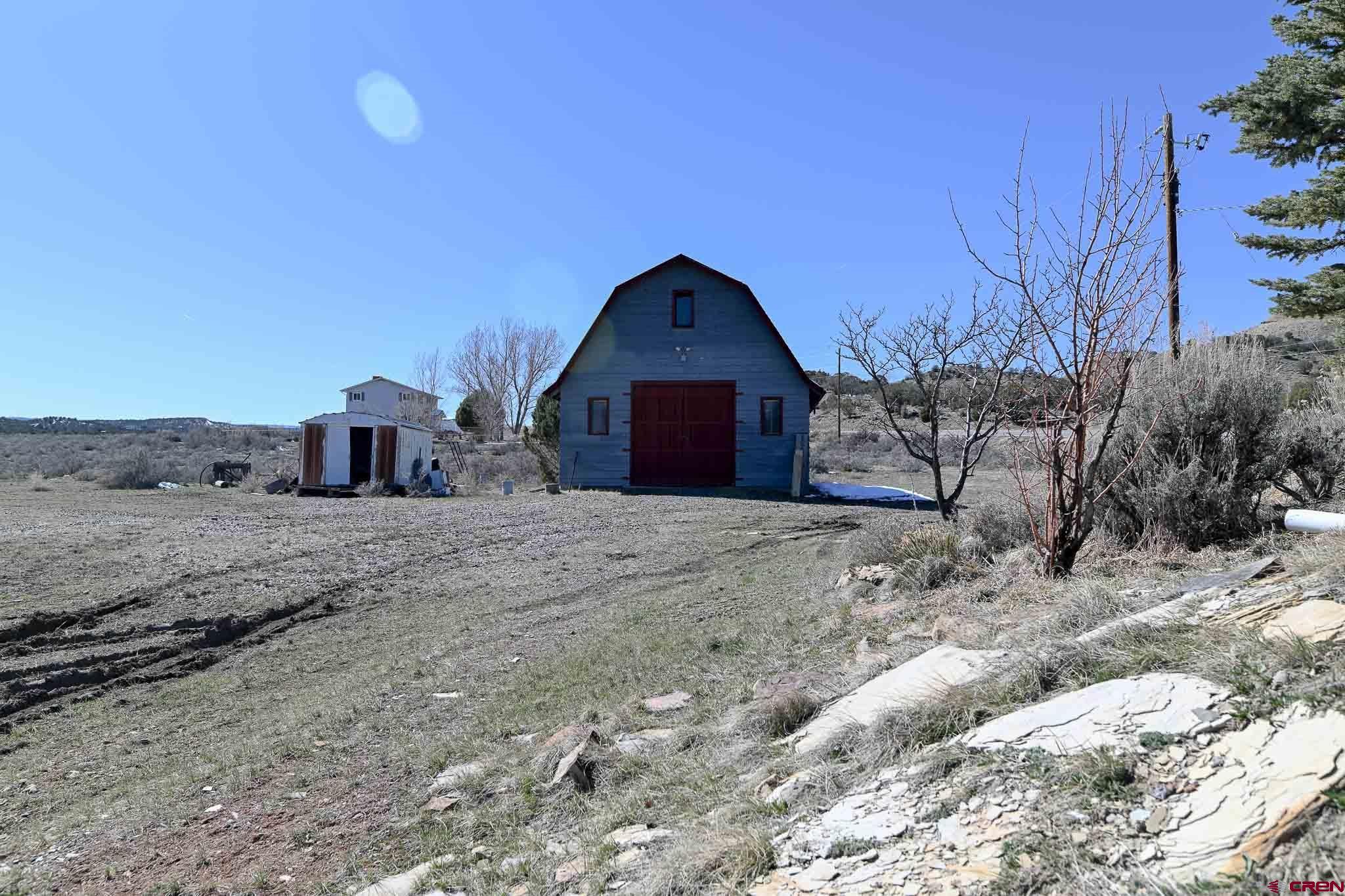 22120 Government Springs Road Montrose, CO 81403 - Photo 28 of 28 a front view of a house with a yard