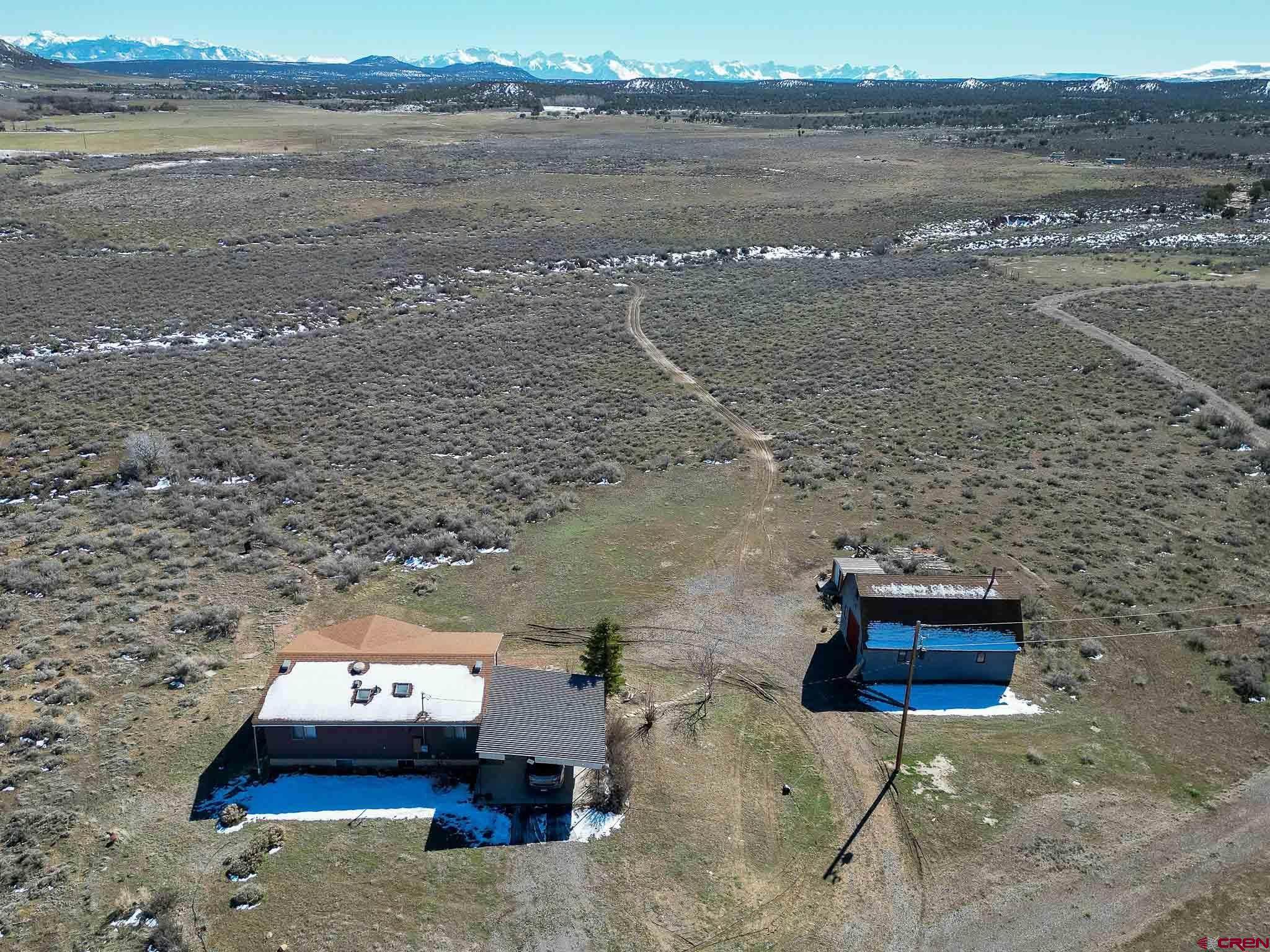 22120 Government Springs Road Montrose, CO 81403 - Photo 3 of 28 a car parked on the side of a lake