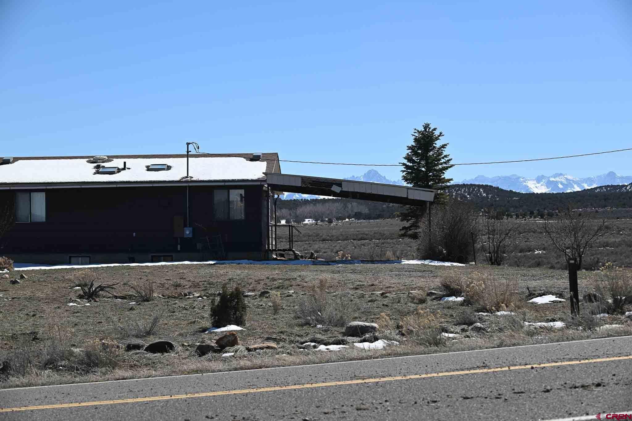 22120 Government Springs Road Montrose, CO 81403 - Photo 8 of 28 a front view of a house with a yard