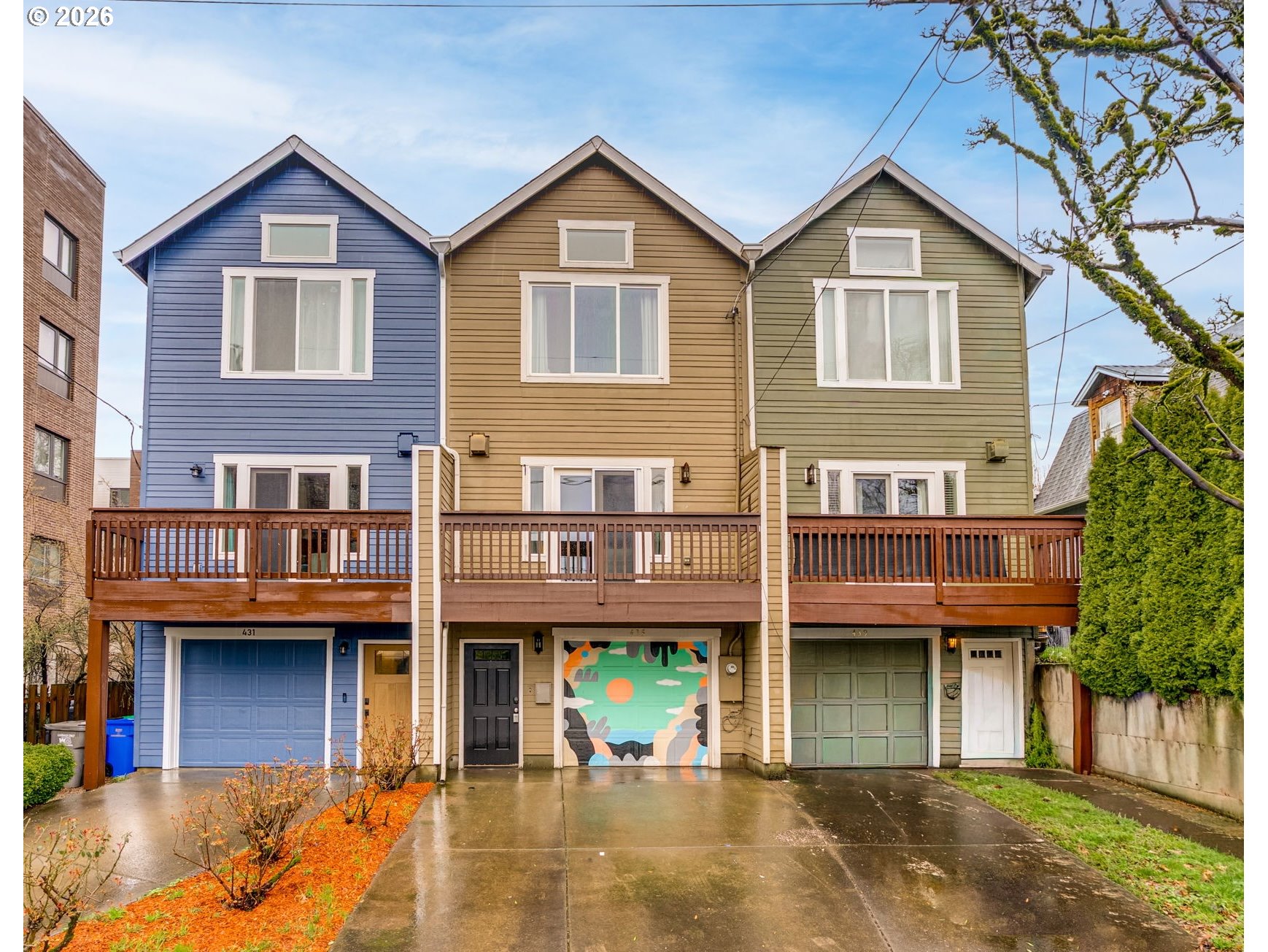 435 Northeast Cook Street Portland, OR 97212 - Photo 1 of 32 a view of a brick house with large windows and a small yard