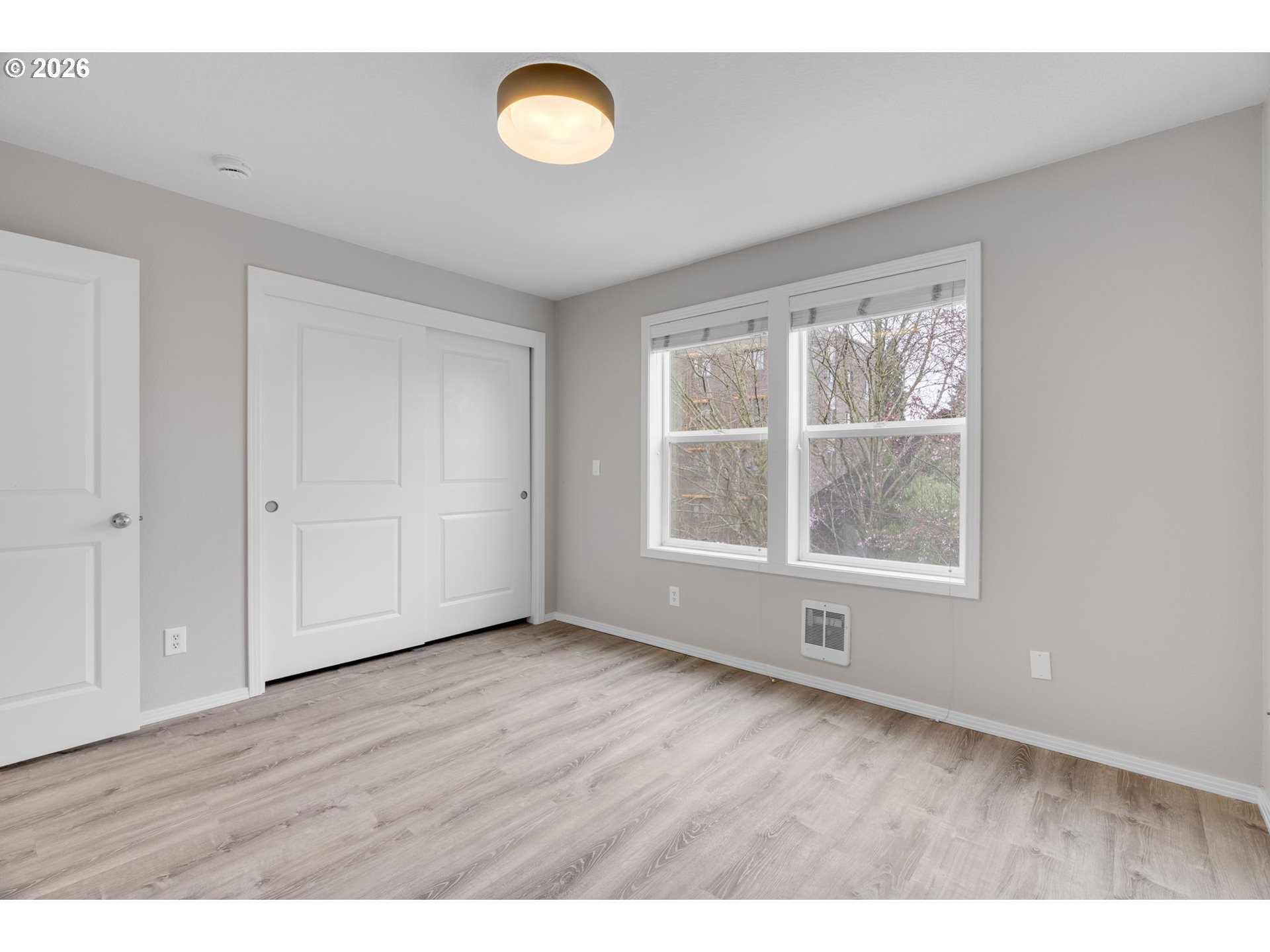 435 Northeast Cook Street Portland, OR 97212 - Photo 18 of 32 a view of an empty room with wooden floor and a window