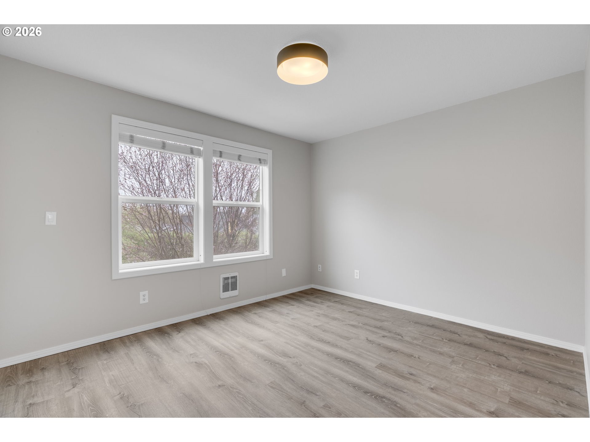 435 Northeast Cook Street Portland, OR 97212 - Photo 19 of 32 a view of an empty room with wooden floor and a window