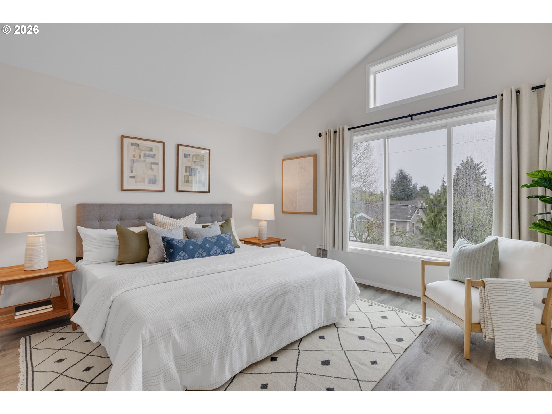435 Northeast Cook Street Portland, OR 97212 - Photo 21 of 32 a bedroom with a large bed and a large window