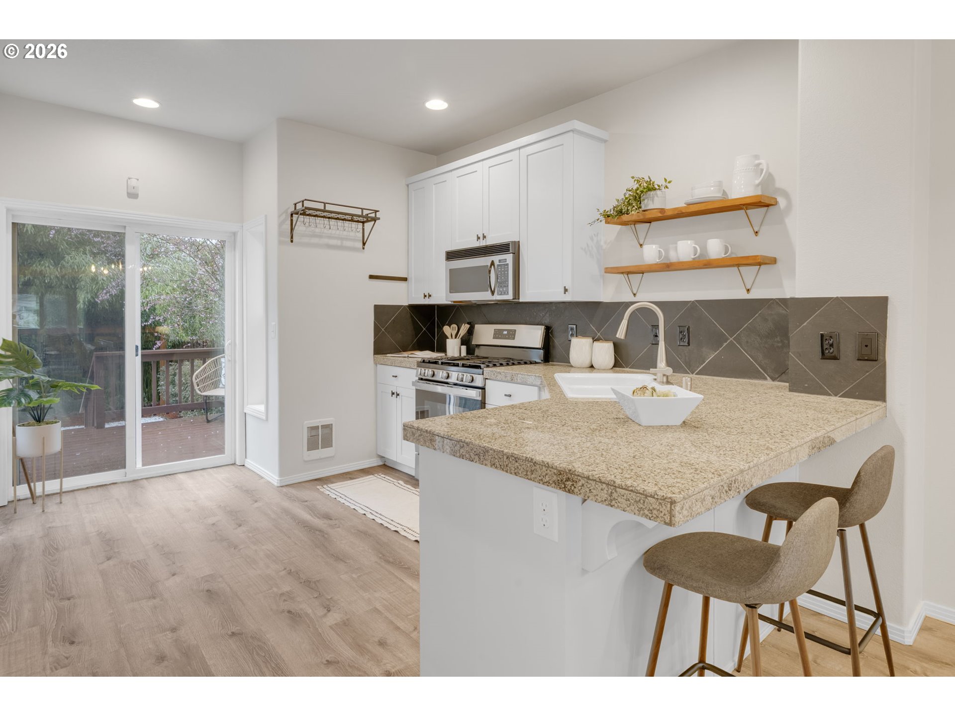 435 Northeast Cook Street Portland, OR 97212 - Photo 6 of 32 a kitchen with a table chairs and refrigerator