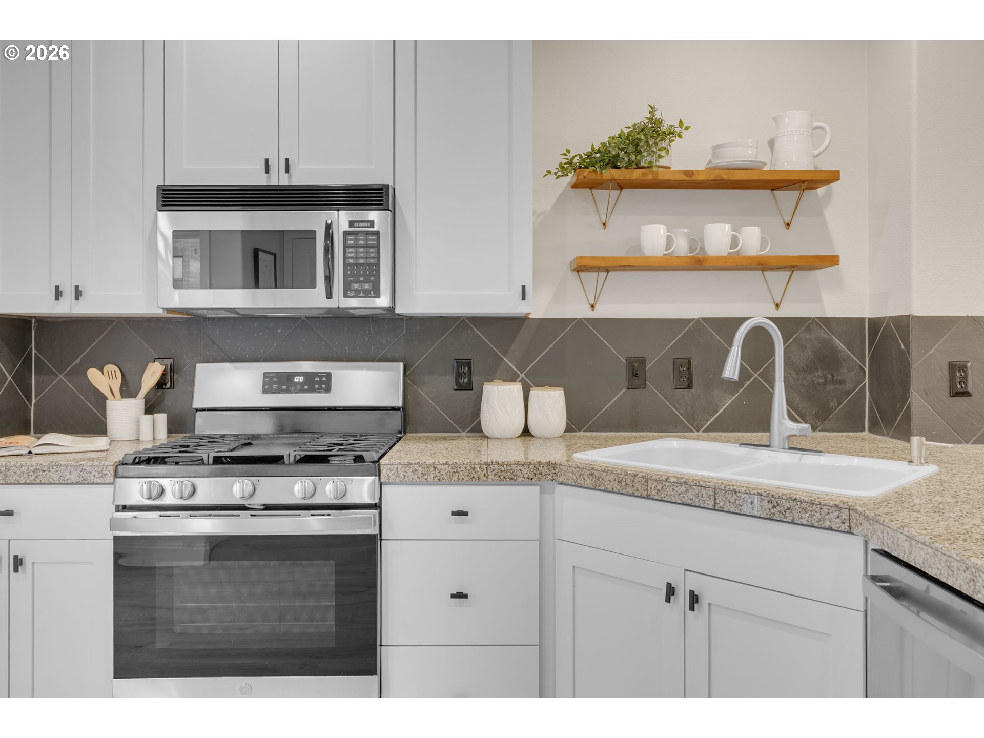 435 Northeast Cook Street Portland, OR 97212 - Photo 7 of 32 a kitchen with a stove and cabinets