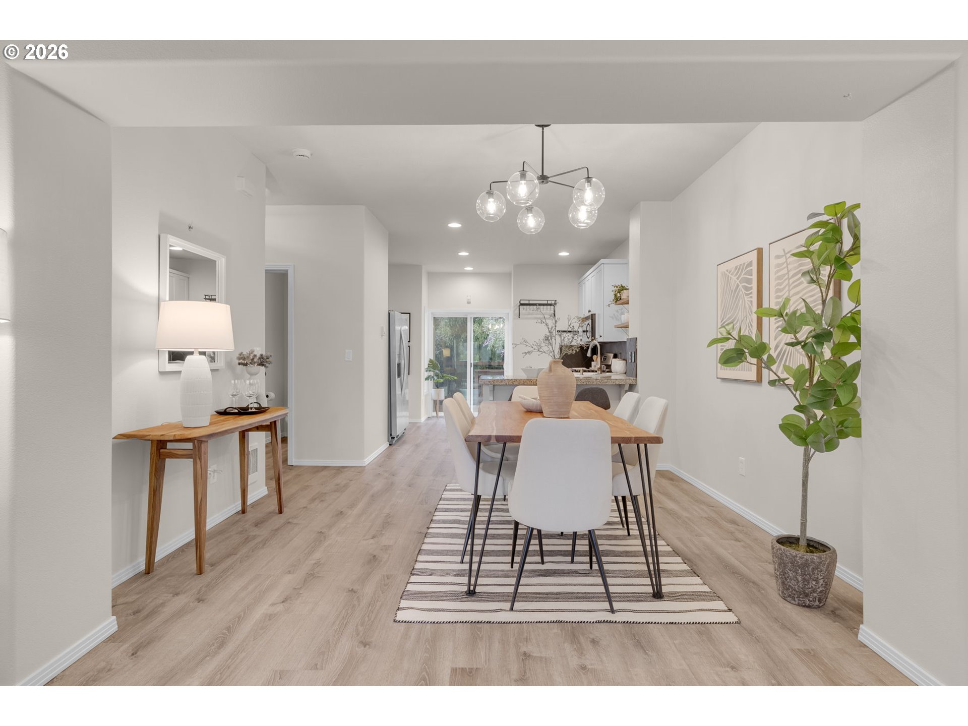 435 Northeast Cook Street Portland, OR 97212 - Photo 10 of 32 a dining room with wooden floor a chandelier a glass table and chairs