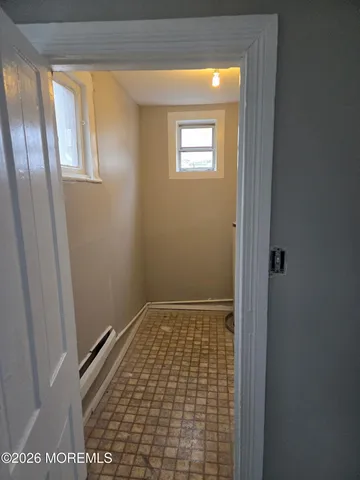 a view of an empty room with windows and closet