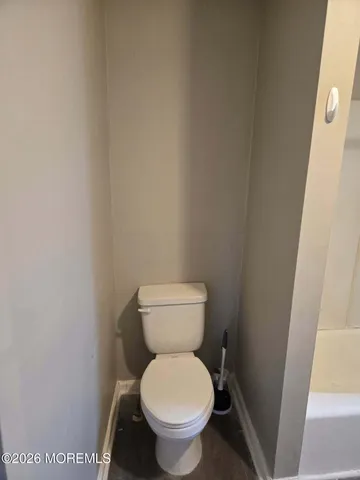 a white toilet sitting next to a small sink