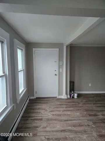 a view of a room with wooden floor