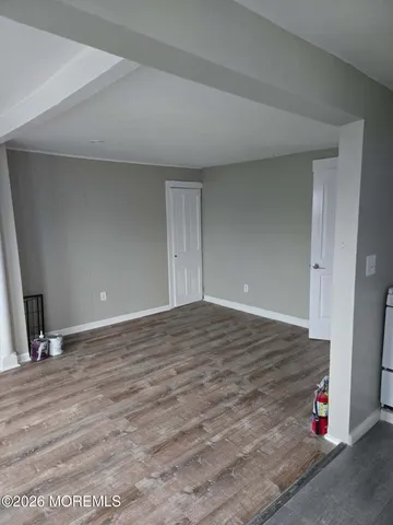 a view of room with wooden floor