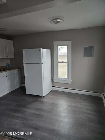 a view of a kitchen with a sink dishwasher and a refrigerator