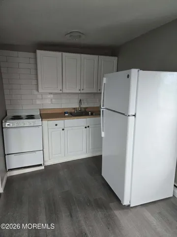 a white refrigerator freezer sitting in a kitchen