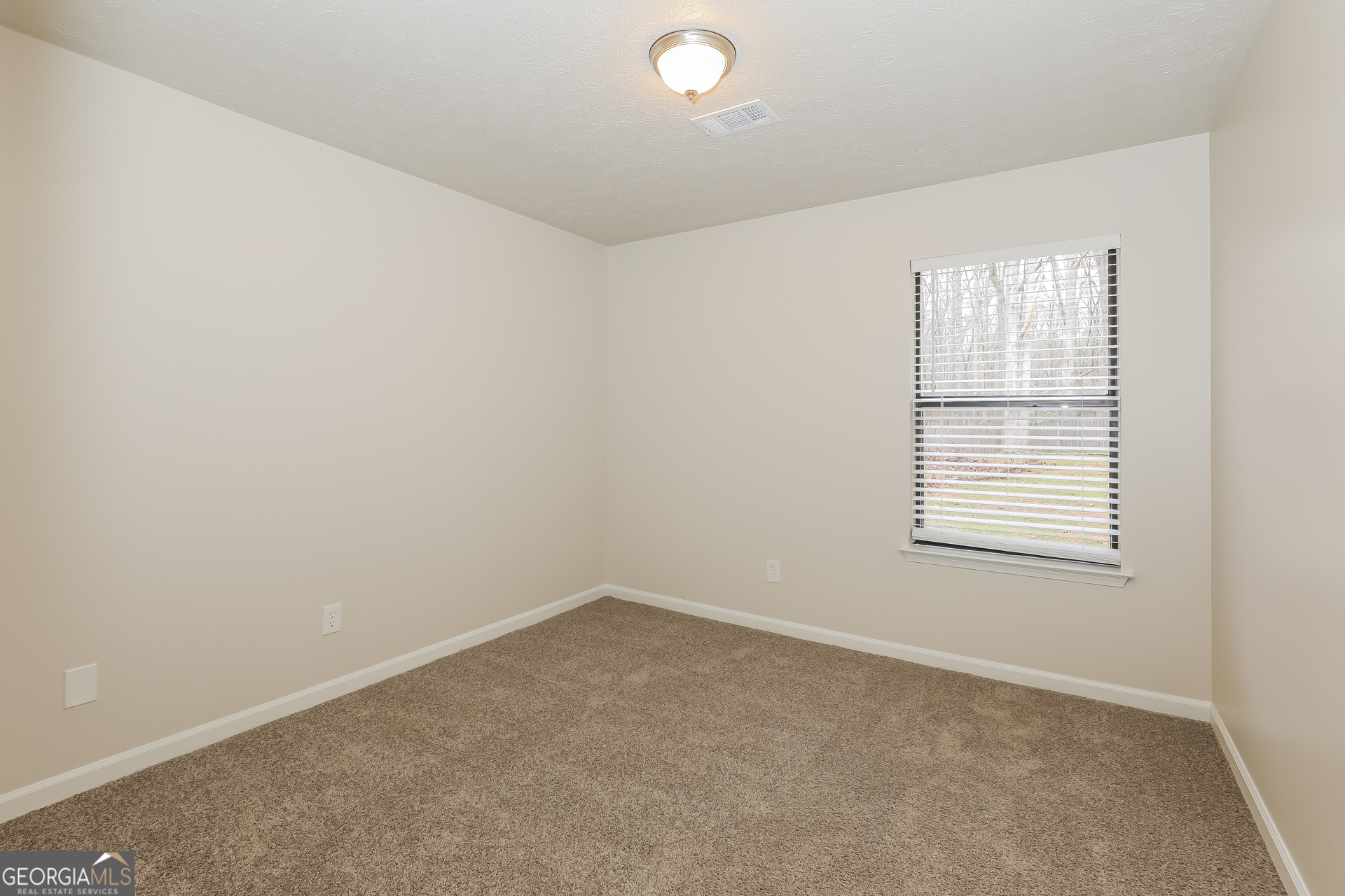 125 Whitney Way Fayetteville, GA 30214 - Photo 11 of 16 an empty room with a window