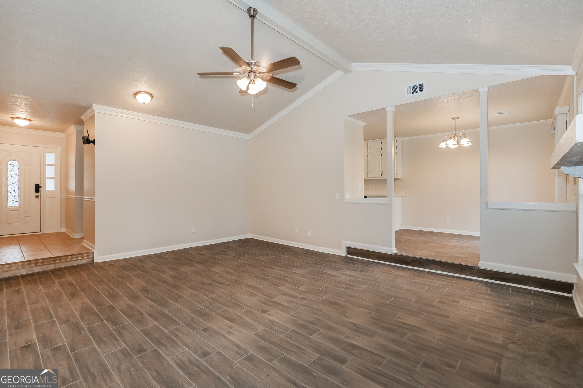 125 Whitney Way Fayetteville, GA 30214 - Photo 4 of 16 a view of an empty room with wooden floor and a window
