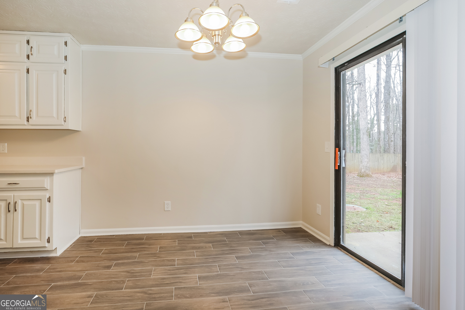 125 Whitney Way Fayetteville, GA 30214 - Photo 6 of 16 a view of an empty room with wooden floor and a window