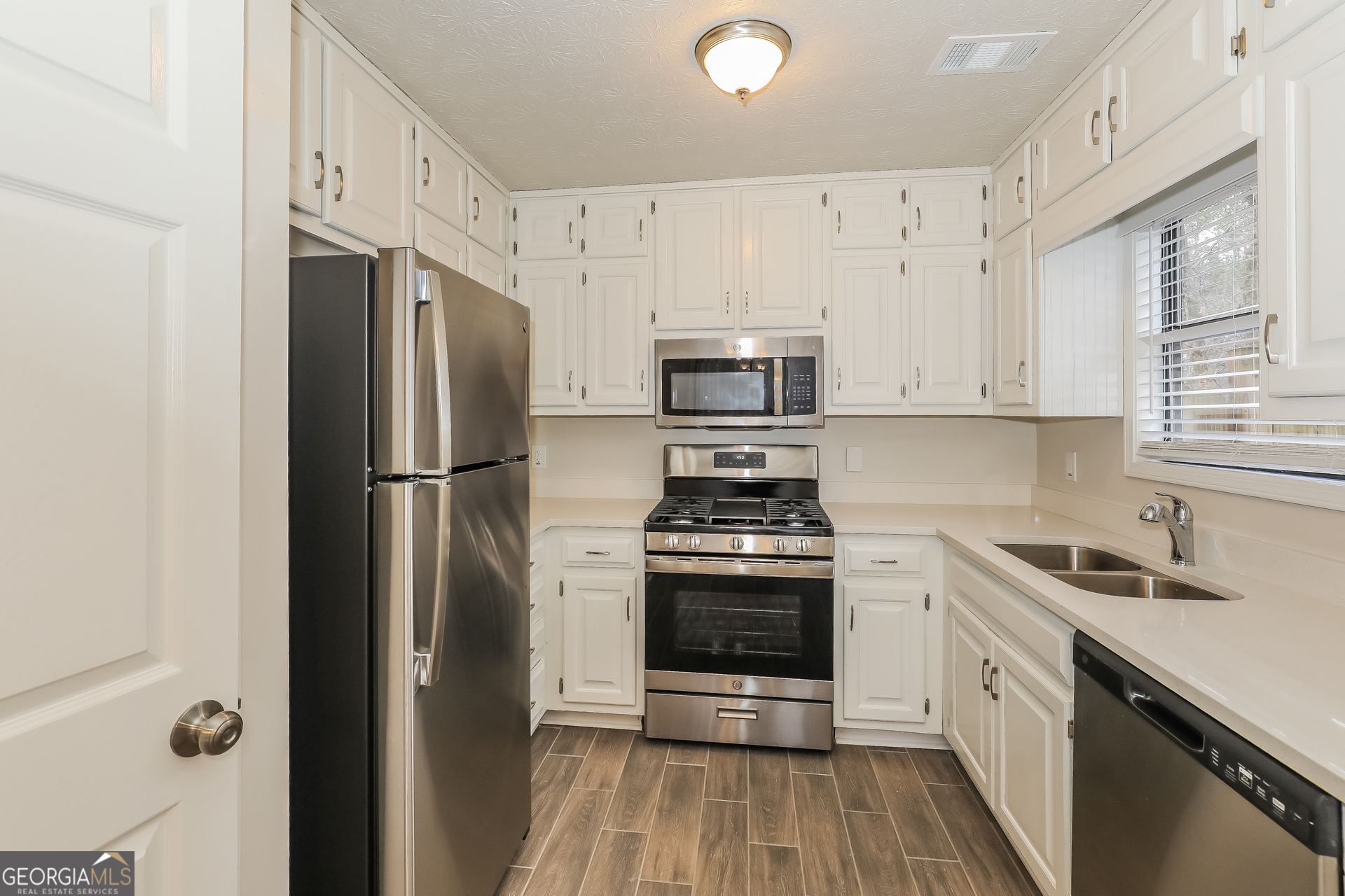 125 Whitney Way Fayetteville, GA 30214 - Photo 7 of 16 a kitchen with stainless steel appliances a refrigerator stove and sink