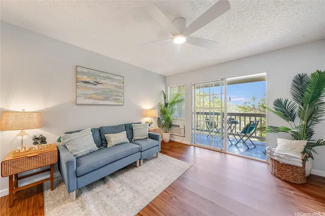 a living room with furniture and a large window with wooden floor