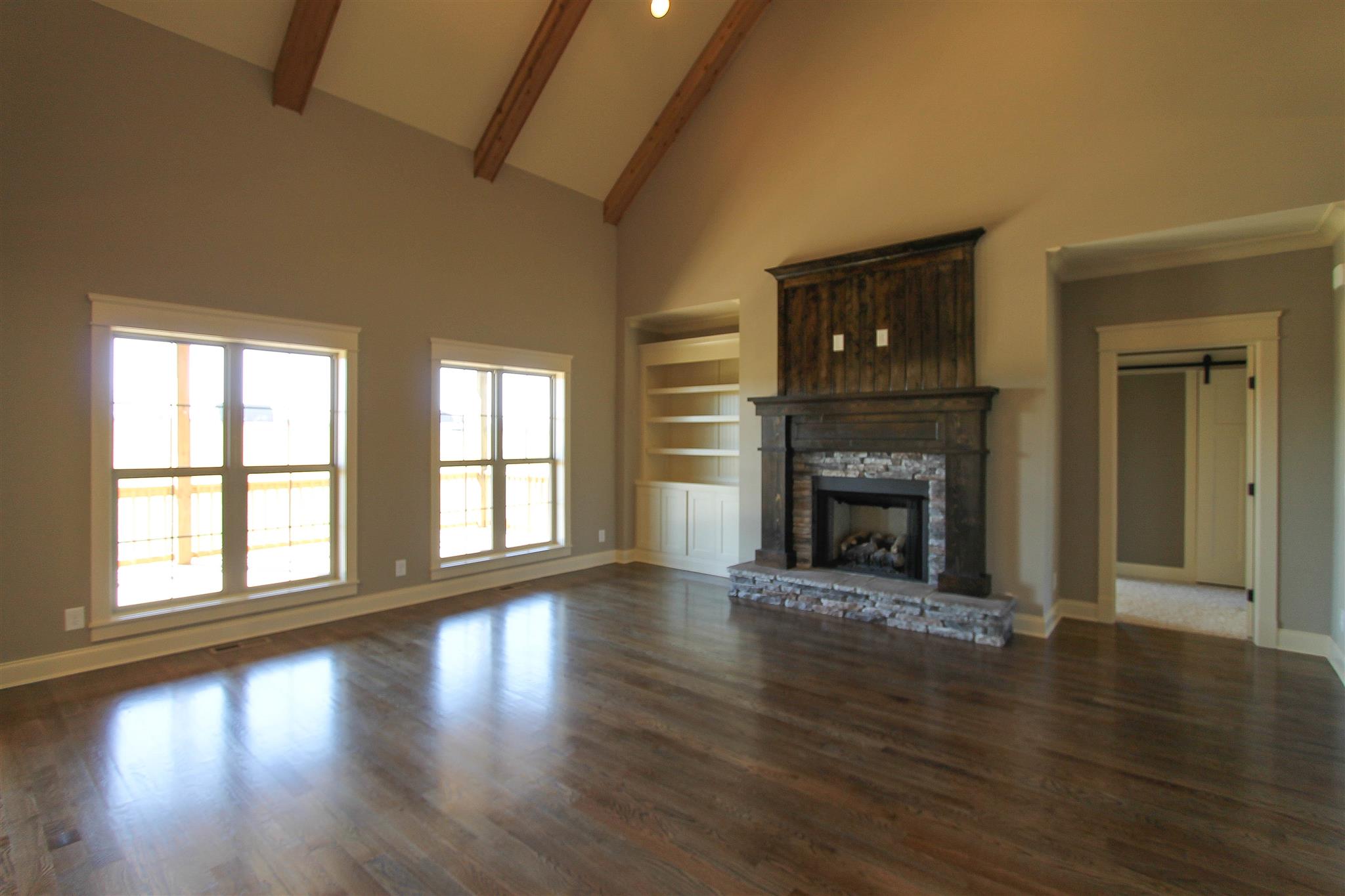 620 Academy Road, Unit 14 Lebanon, TN 37087 - Photo 6 of 24 wooden floor fireplace and windows in an empty room