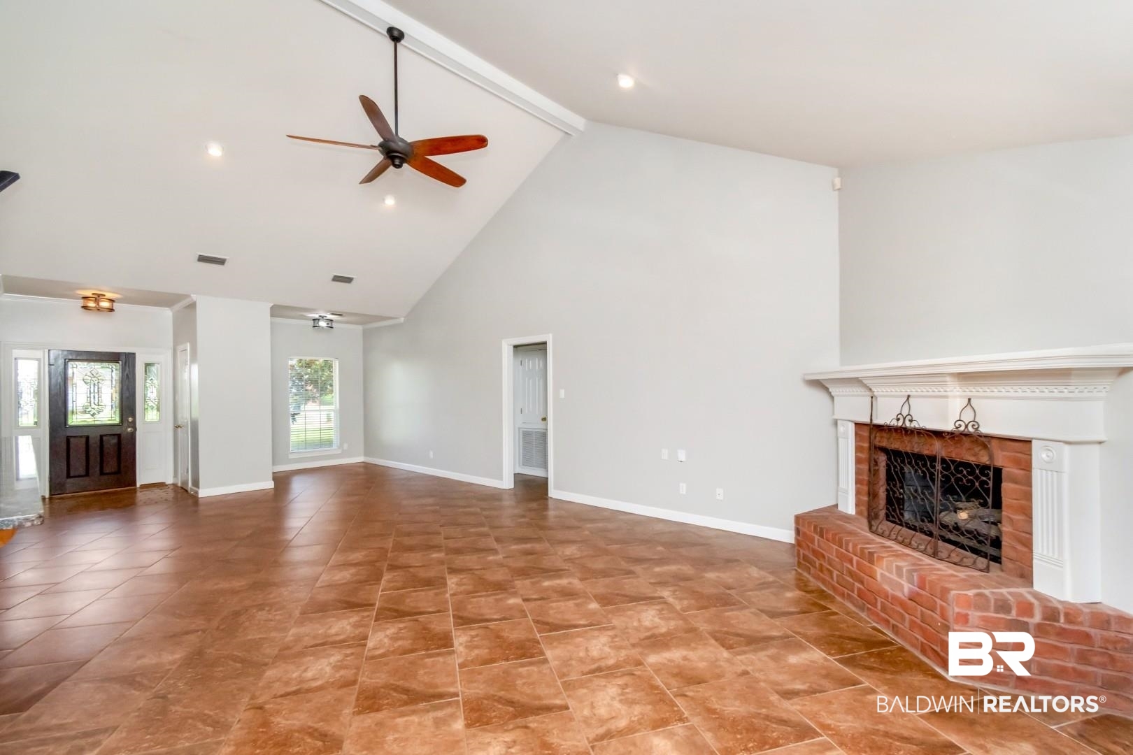 10691 Hunters Ridge Drive Mobile, AL 36695 - Photo 9 of 37 Expansive living space featuring vaulted ceilings, ceiling fans, recessed lighting, and large format tile flooring
