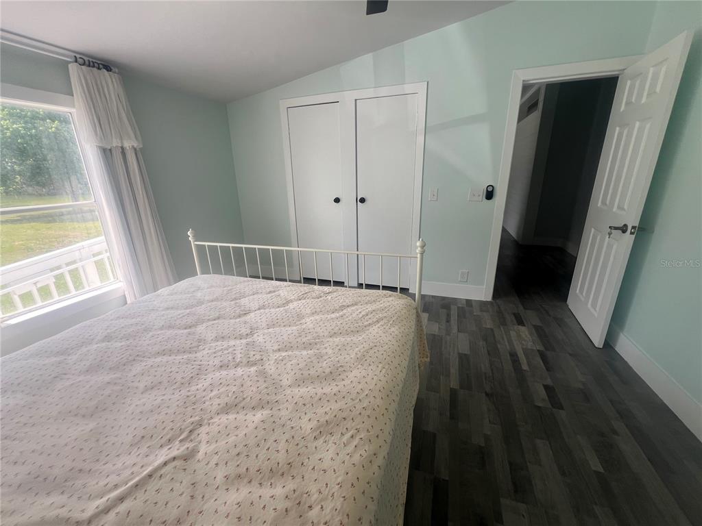 5855 Jack Brack Road St. Cloud, FL 34771 - Photo 72 of 86 a bedroom with a bed and a large window