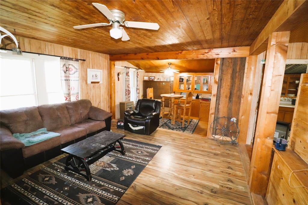 10543 Old Joy Shannon Road Henrietta, TX 76365 - Photo 11 of 36 a living room with furniture and a chandelier