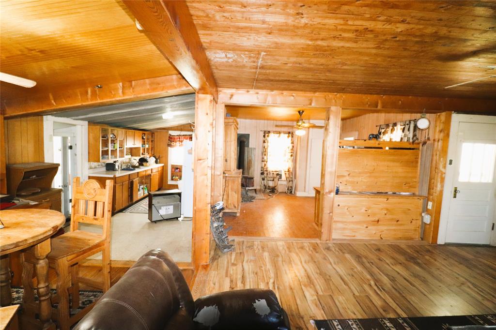 10543 Old Joy Shannon Road Henrietta, TX 76365 - Photo 14 of 36 a living room with furniture and a table with wooden floor
