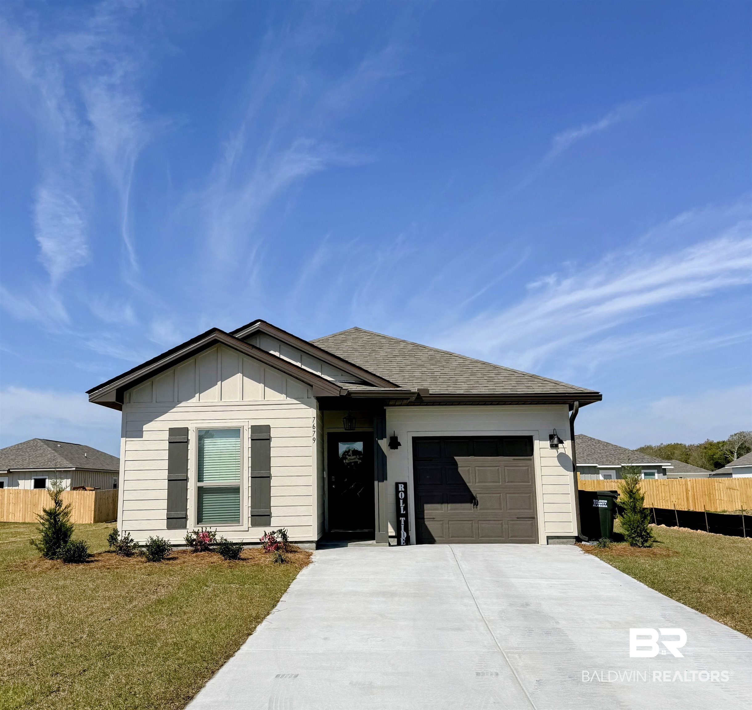 7679 Sable Drive Foley, AL 36535 - Photo 1 of 34 Ranch-style house with board and batten siding, driveway, an attached garage, and roof with shingles