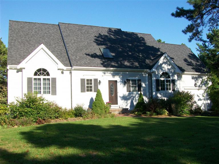 71 Meadowbrook Road Mashpee, MA 02649 - Photo 1 of 14 a front view of a house with a garden